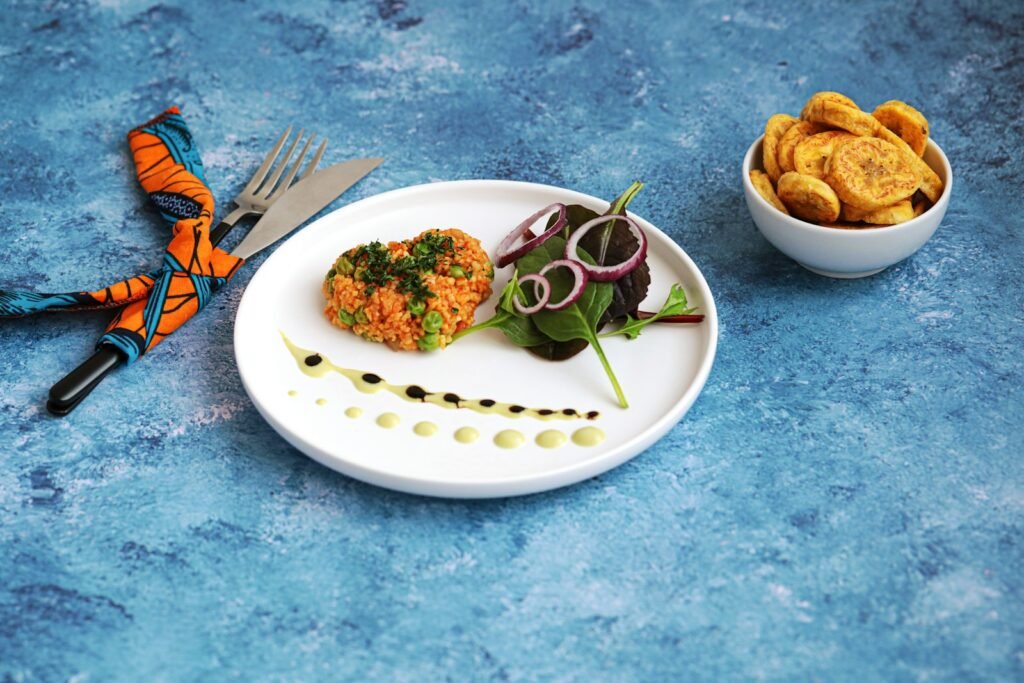 A plate and a bowl of African food on a table