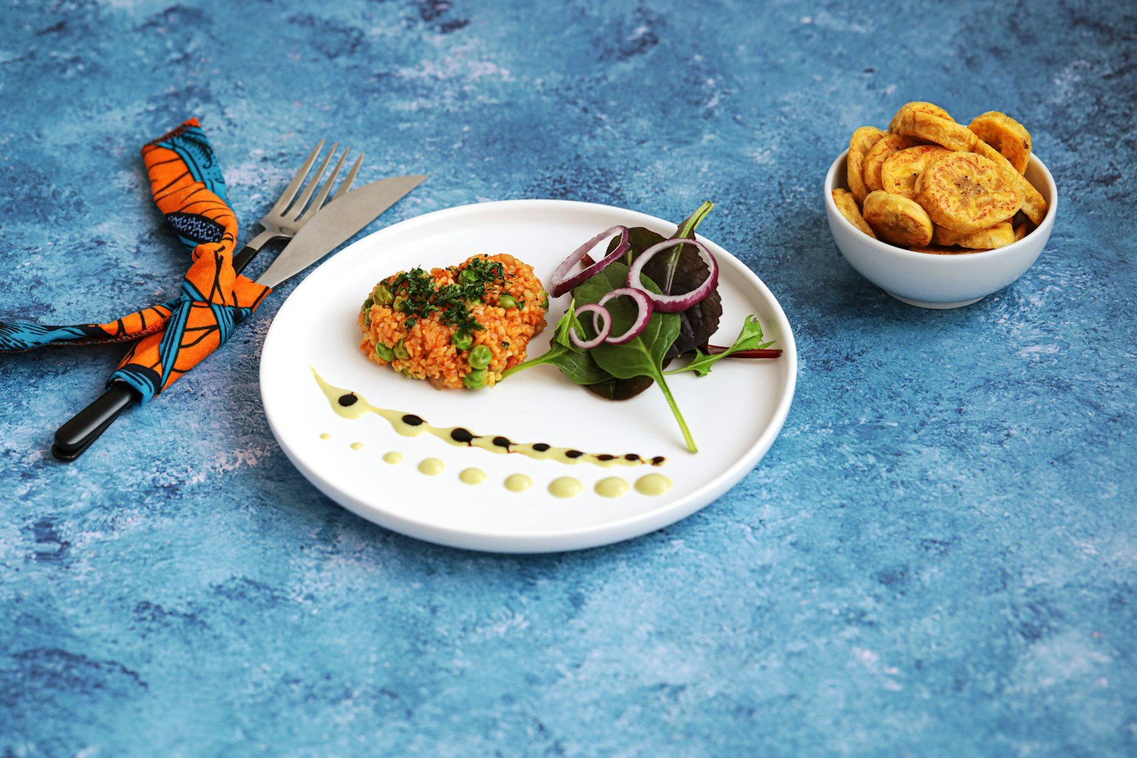 A plate and a bowl of African food on a table