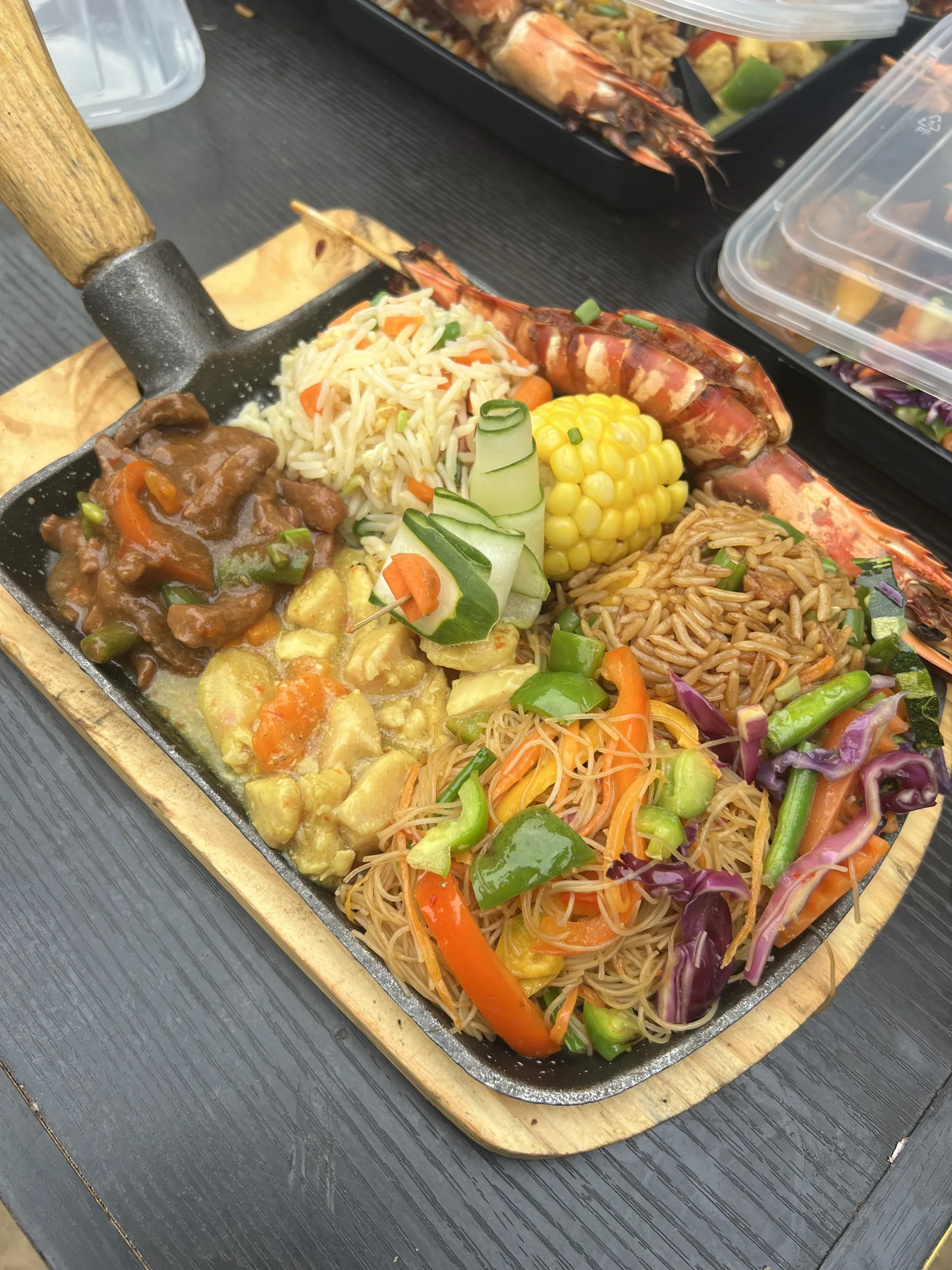 Sizzling platter of stir-fried noodles, rice, prawns and vegetables by Cabbilicious Foods